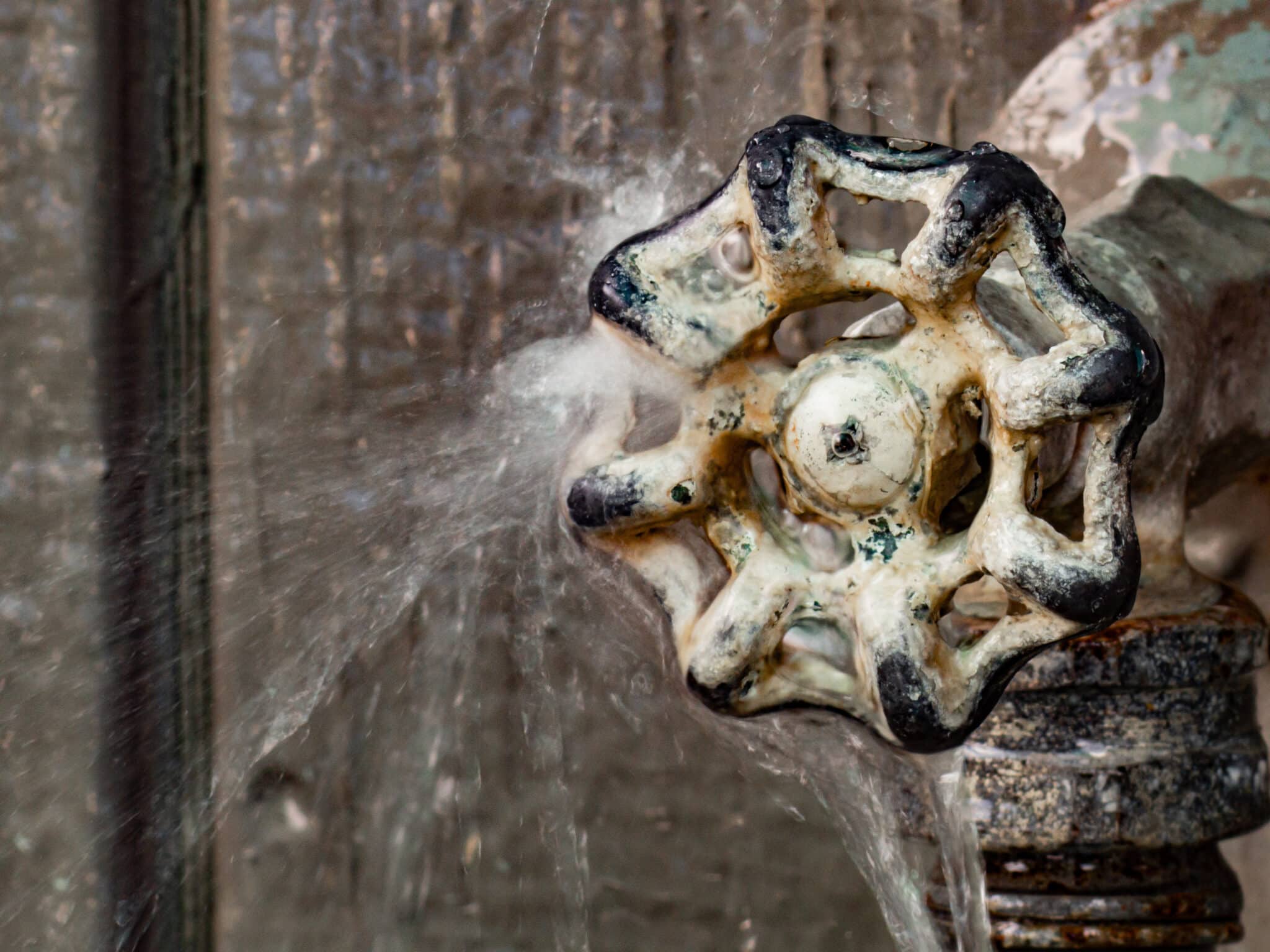 Water leaking freely from a pipe, Emergency Plumbing Response.