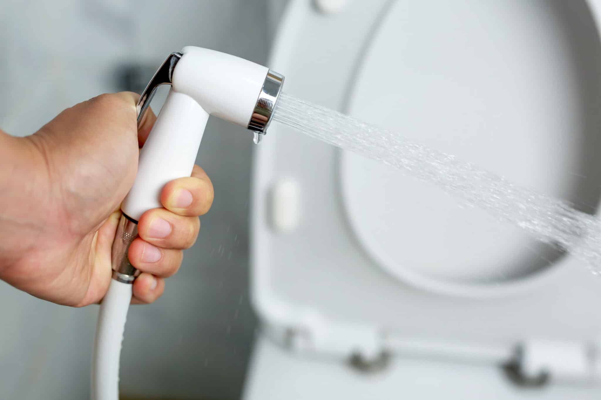 White handheld bidet sprayer in toilet bathroom water pressure, bidet sprayer install.