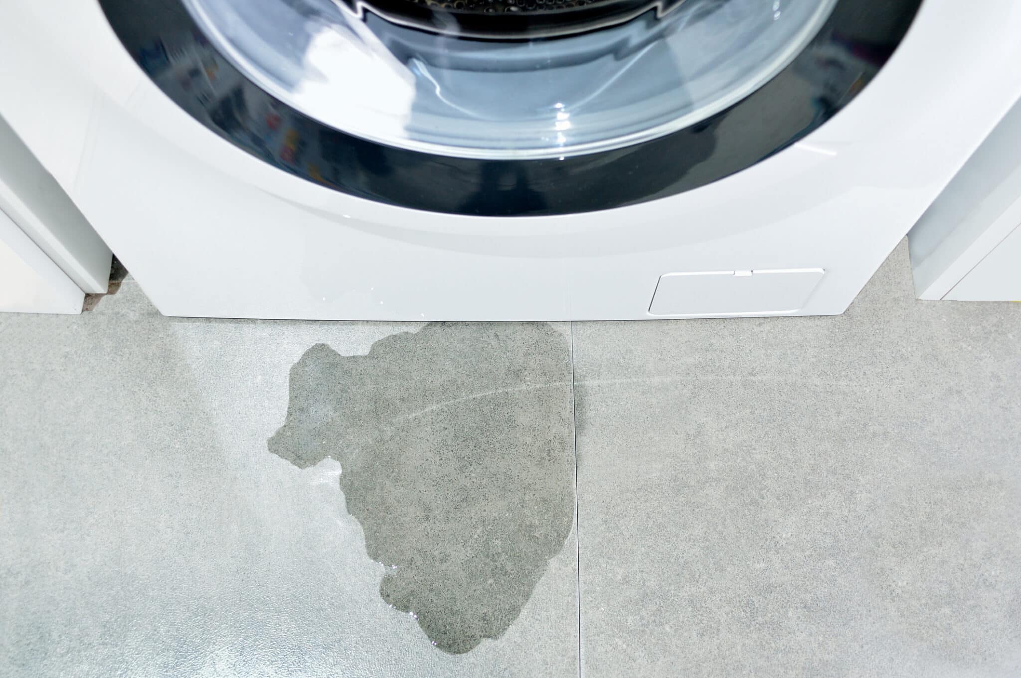 Image of a washing machine with drain pipe leaking water, laundry standpipe height.